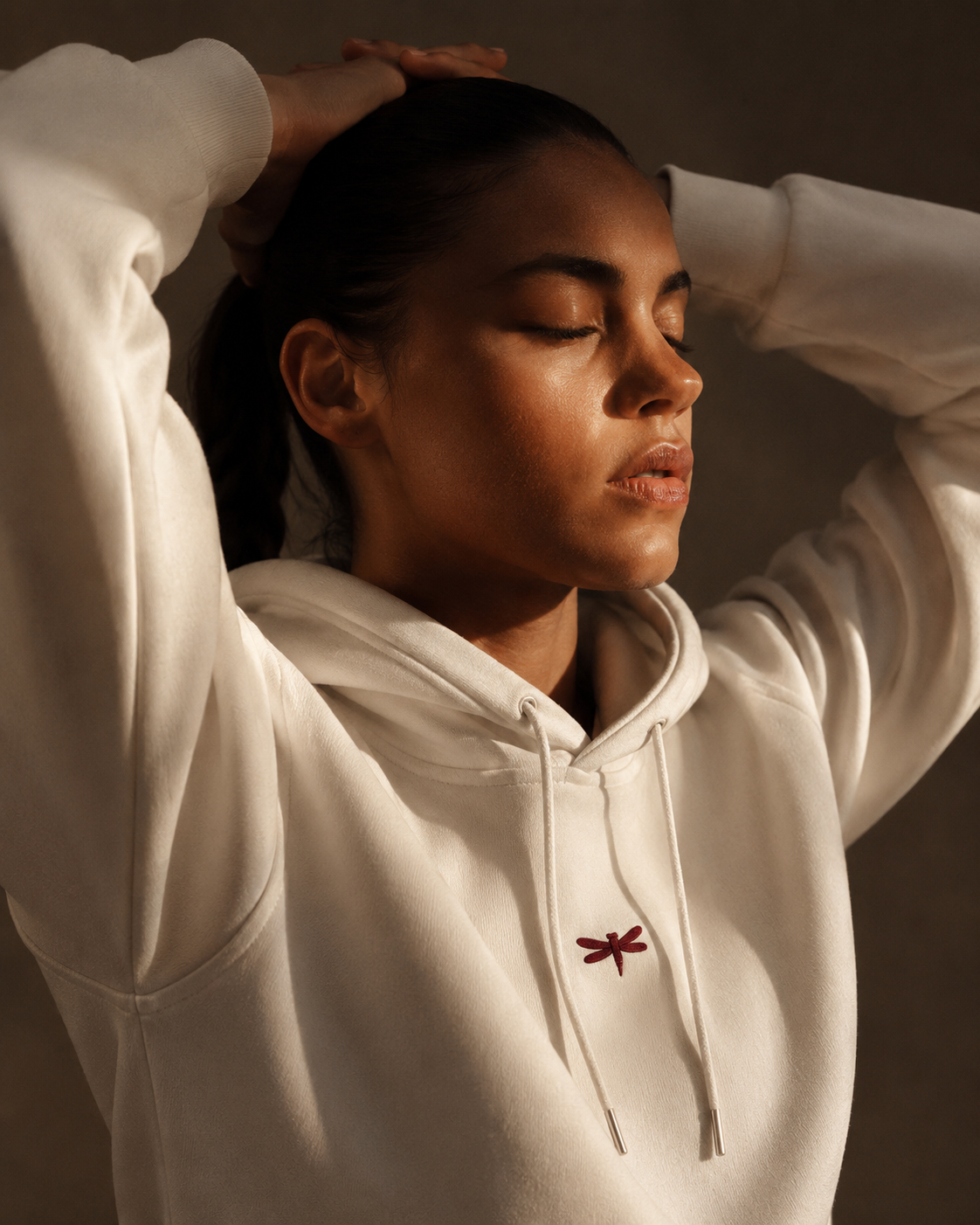 Woman wearing the white hoodie in warm light