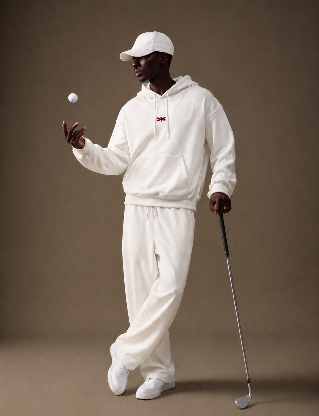 Man wearing the white hoodie with a golf club