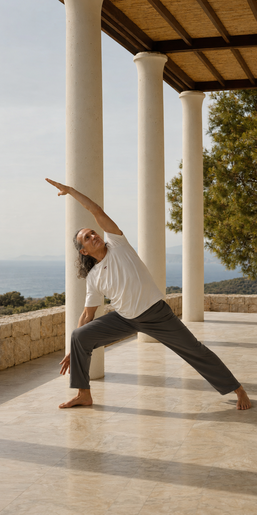 A man practicing a standing side stretch by the sea